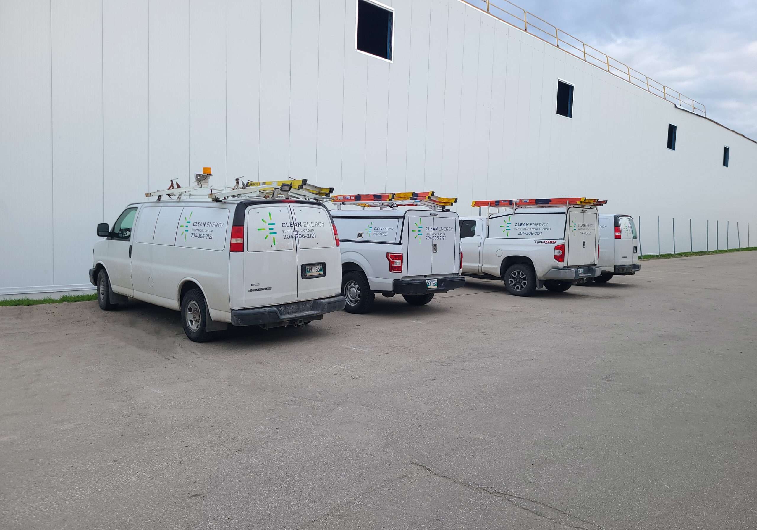 1000009578-2 CEEG service vehicles outside a commercial building, shown alongside the electrical services FAQ