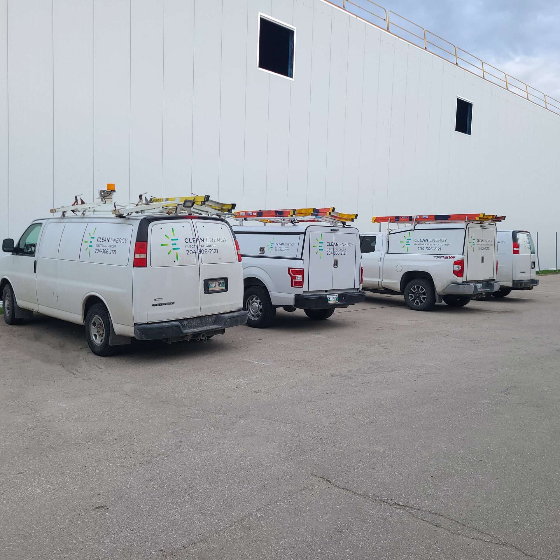 1000009578-2 CEEG service vehicles outside a commercial building, shown alongside the electrical services FAQ