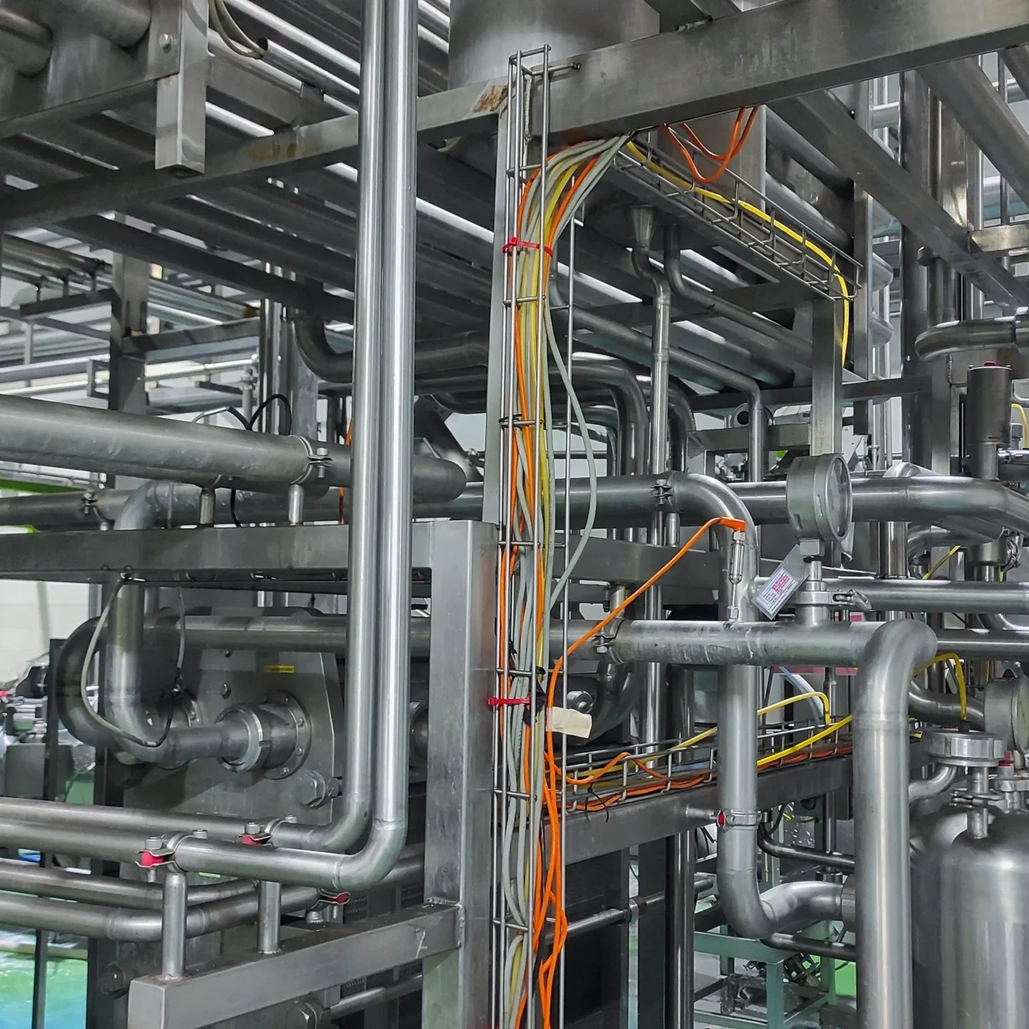 Stainless steel pipe, cable and valve in production room of factory Stainless steel pipe, cable and valve in production room of factory